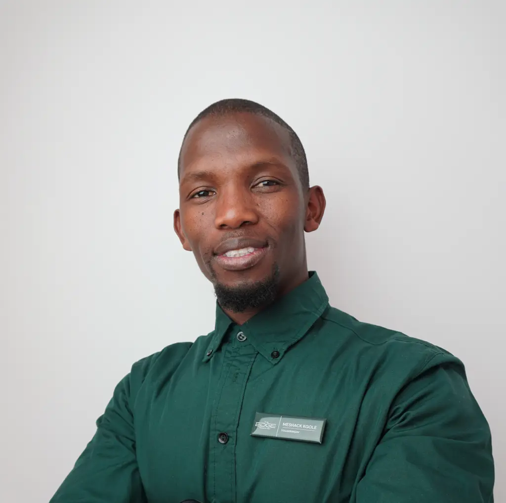 Smiling man in a green shirt, representing our team on the About us page, showcasing professionalism and approachability.